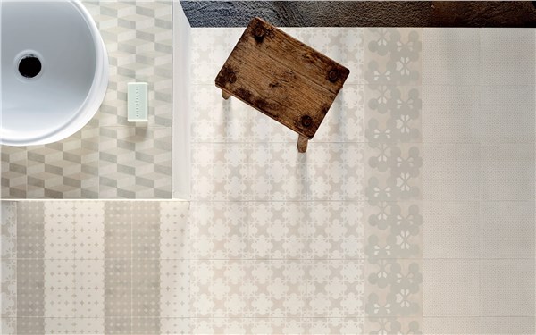 Rivestimento a piastrelle decorate bianche con lavabo tondo e tagliere in legno