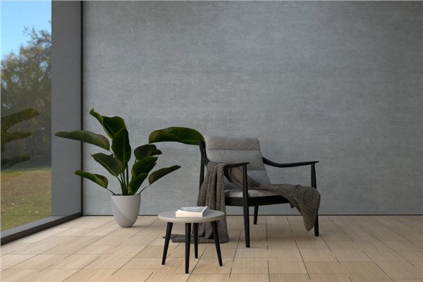 Ambiente minimale con parete effetto cemento, poltrona e pianta