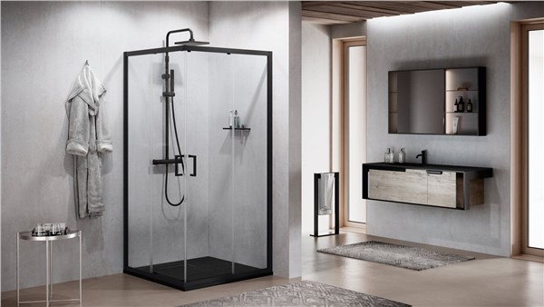 Box doccia angolare con profili neri accanto a un mobile bagno sospeso