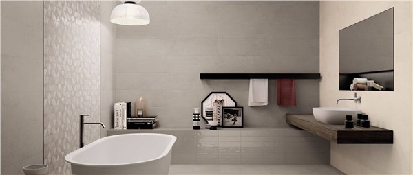 Bagno con rivestimento a rilievo fino a mezza altezza, vasca e doppio lavabo