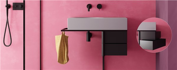 Lavabo integrato su mobile scuro con parete rosa e miscelatori neri