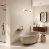 Bagno moderno con vasca ovale freestanding, piastrelle Ceramica Del Conca Sensoria ed elegante doccia walk-in.